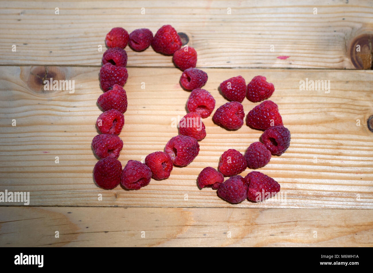Alphabetical letters made of raspberries on a white background Stock ...