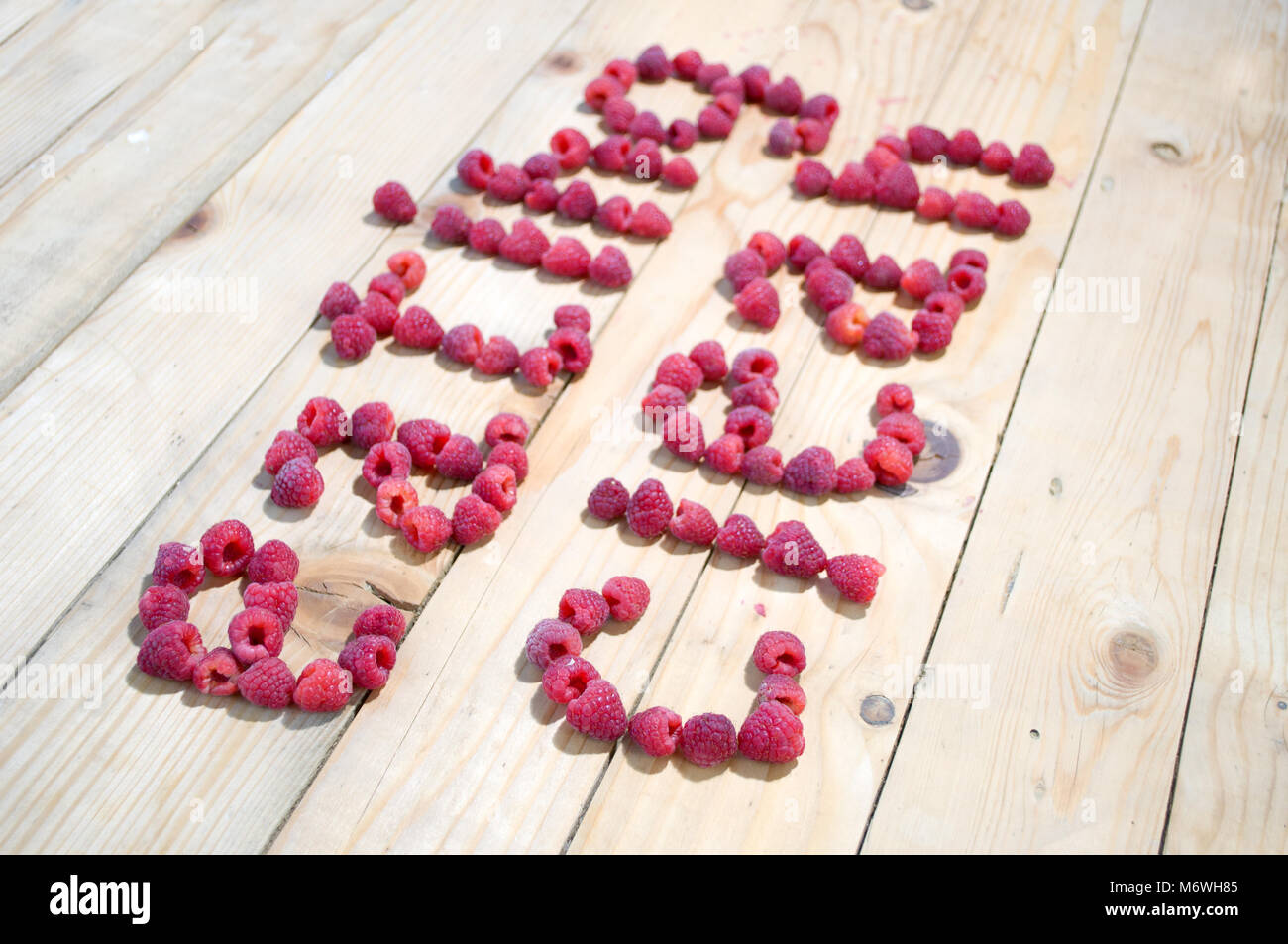Written Eating clean, with raspberry Stock Photo - Alamy