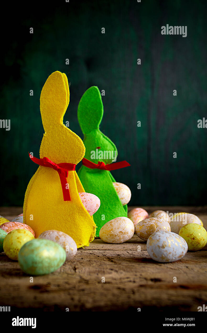 Easter rabbit and eggs on wooden table. Copy space. Stock Photo