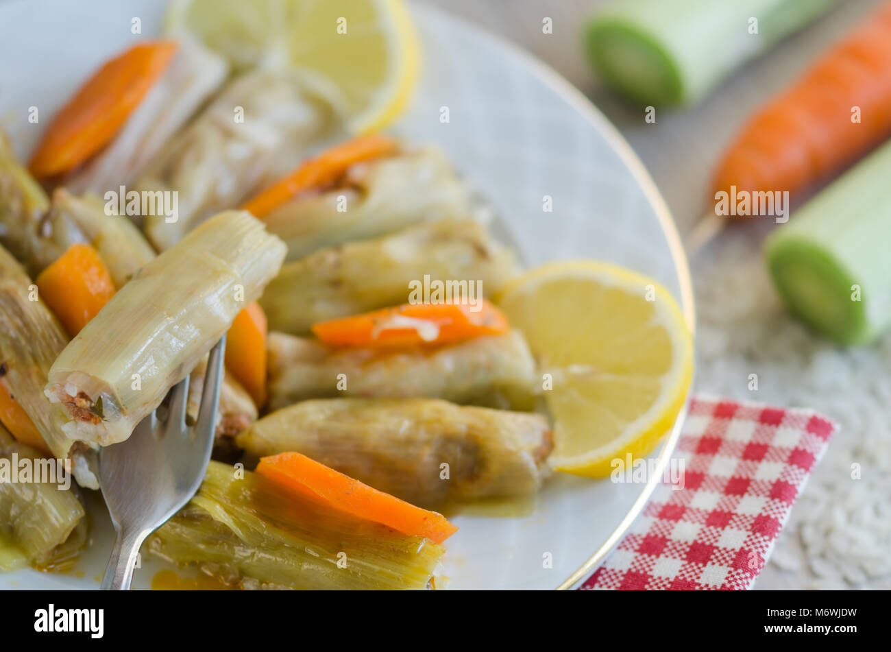 Leek Wrapped Traditional leek wrap with meat and rice on the whitw plate Stock Photo ...