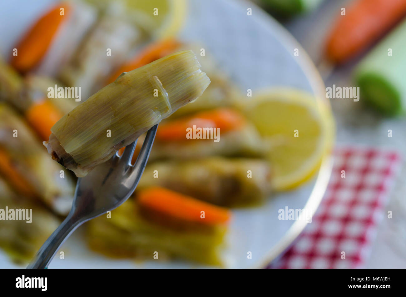 Leek Wrapped Traditional leek wrap with meat and rice on the whitw plate Stock Photo ...