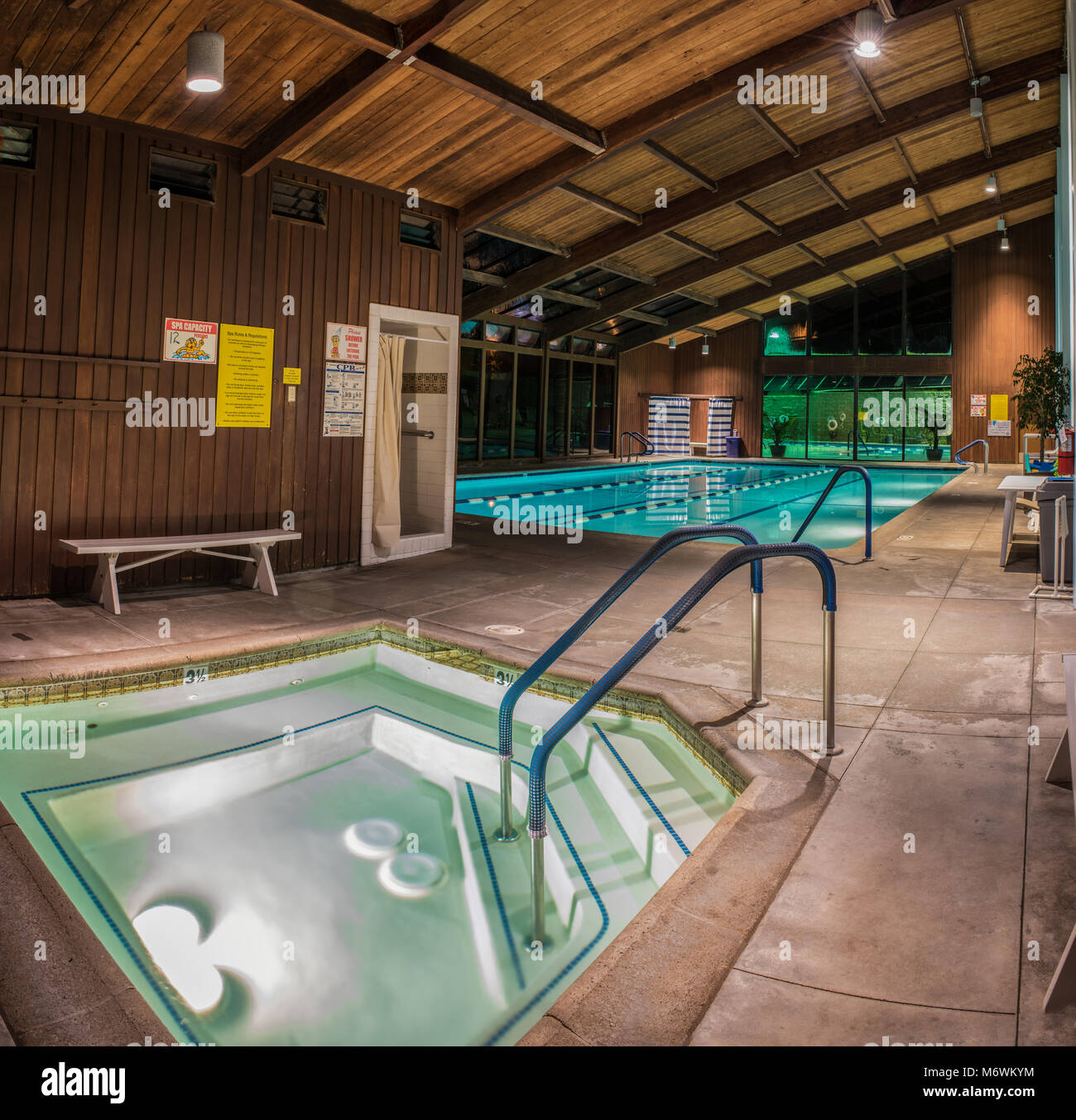 Jacuzzi, therapy pool, and further back, the lap pool of the Pierpont Racquet Club under morning lights in Ventura, California on March 6, 2018 in Uni Stock Photo