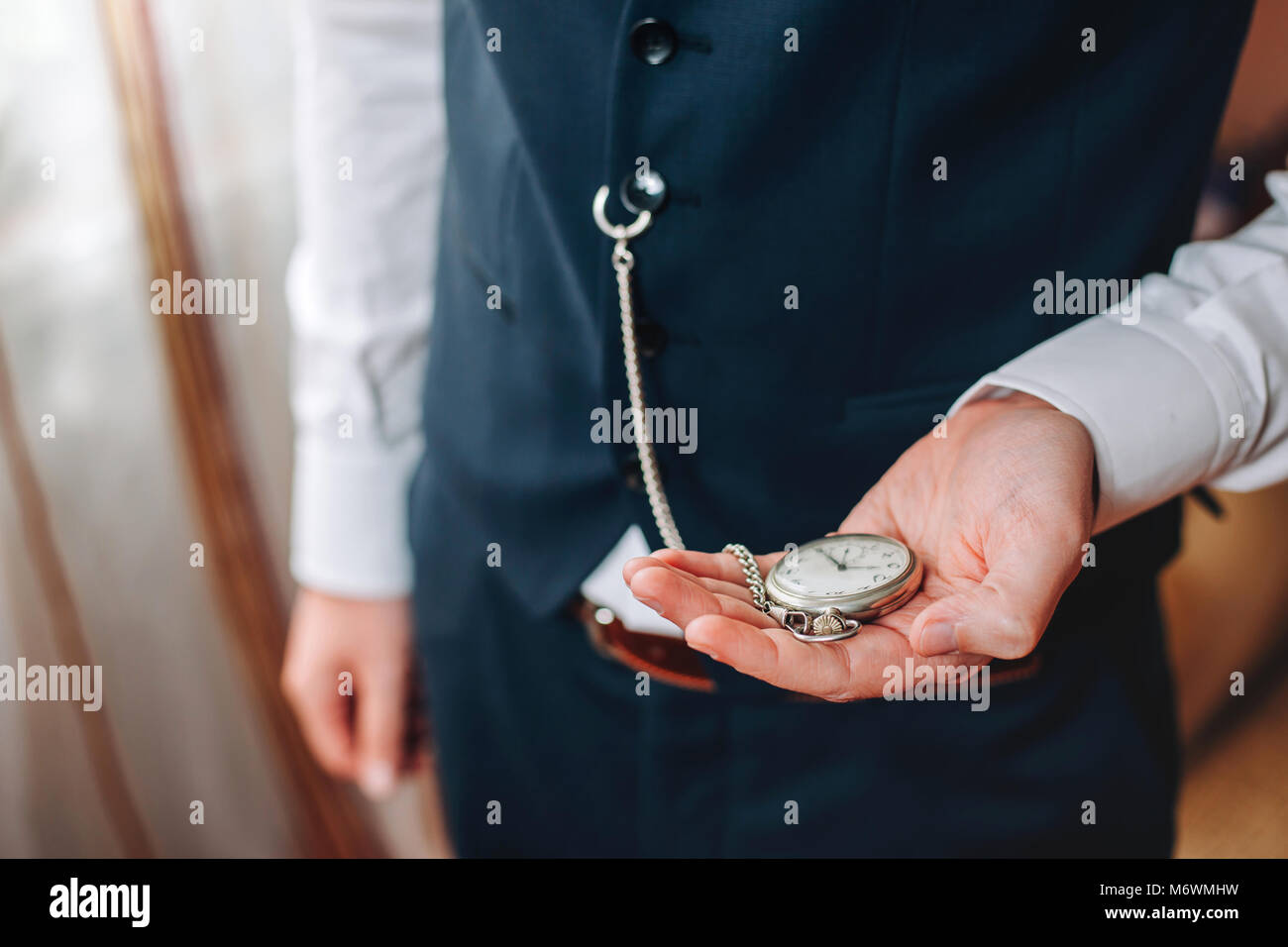 Business man with pocketwatch Stock Photo