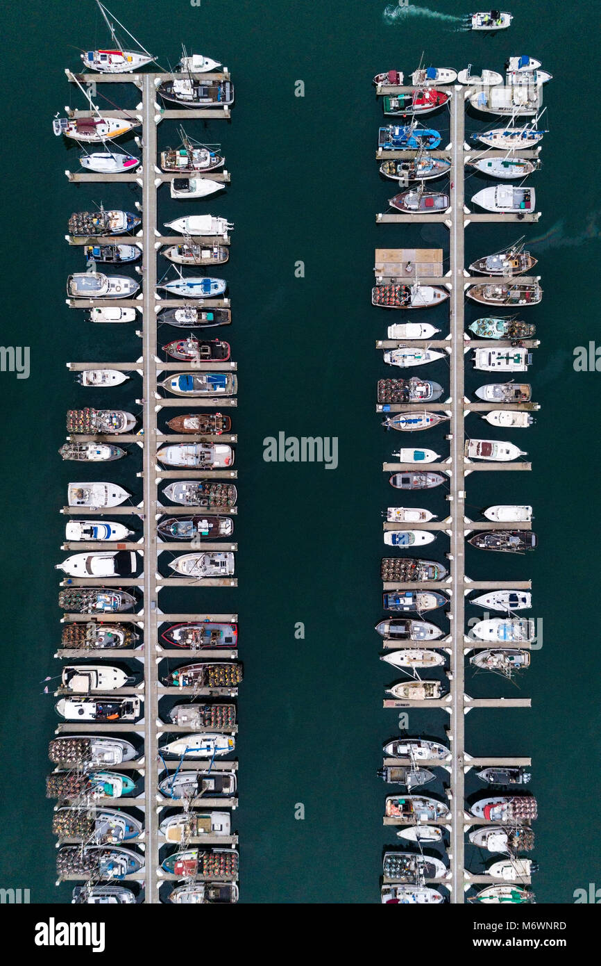An aerial view of boats docked in Spud Point Marina, many filled with crab pots, in Bodega Bay, California. Stock Photo
