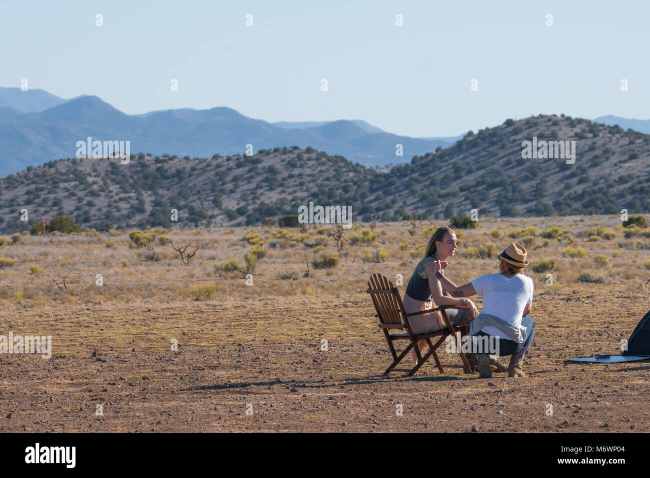 Two women talk while on a photography set in Santa Fe, New mexico on the high desert. Stock Photo
