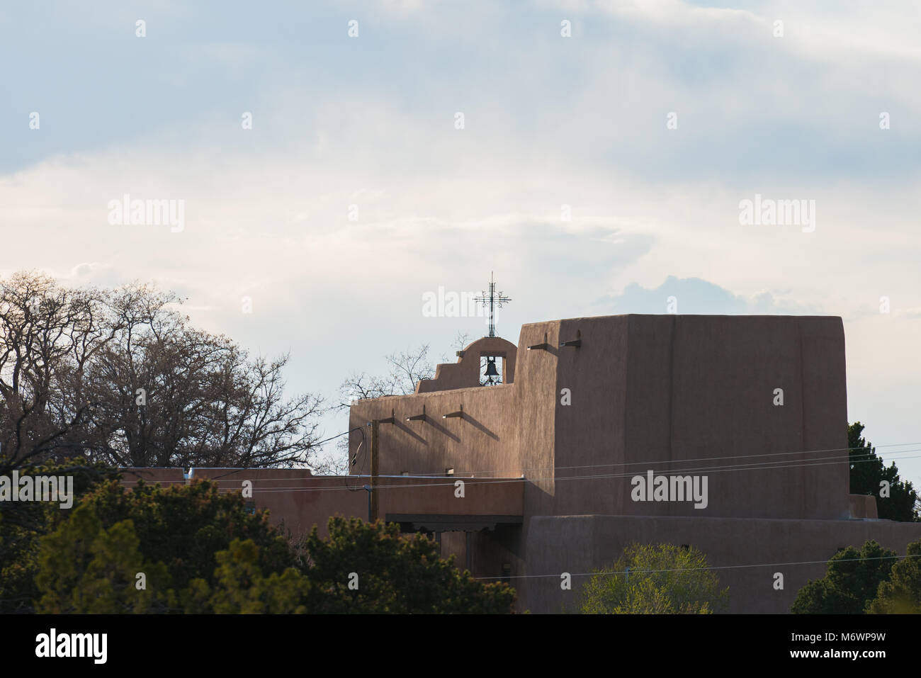 A church nestled in the high desert hillside of Santa Fe, New Mexico