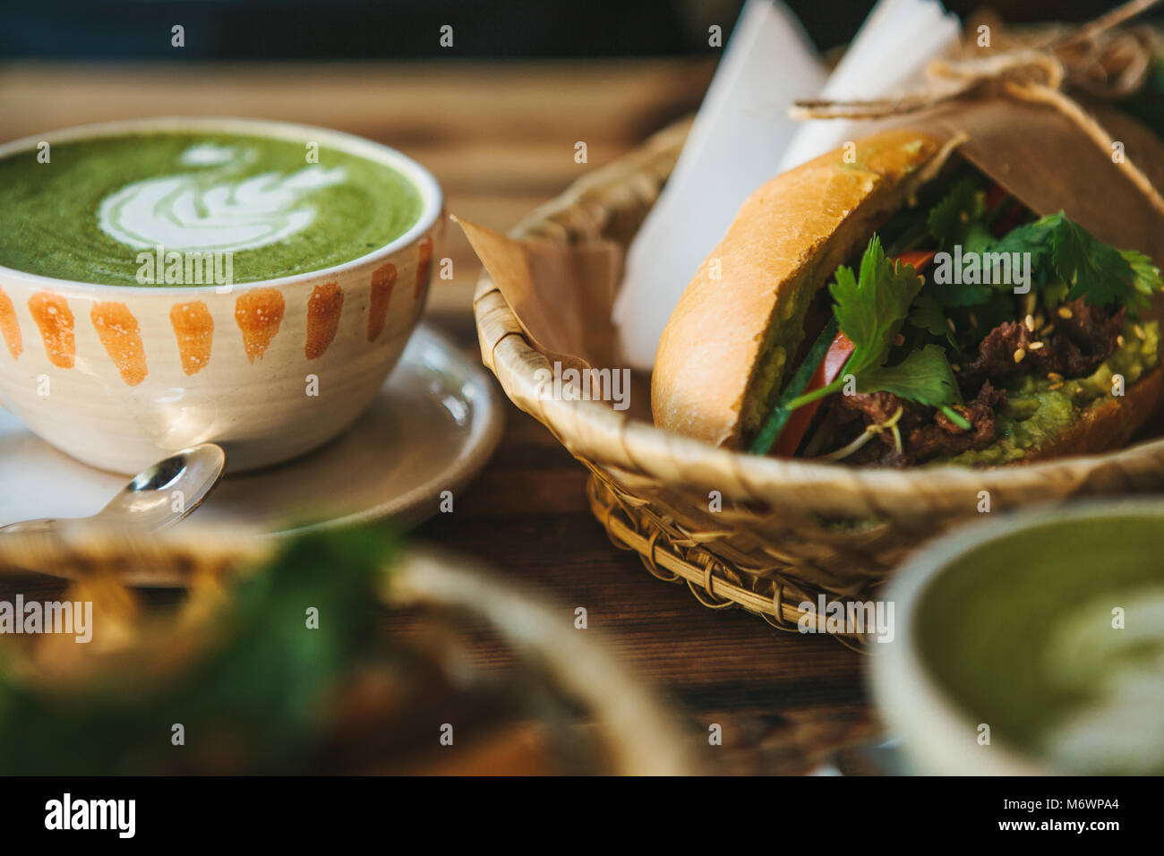 Ceramic cup with green tea called Matcha and a sandwich near Stock Photo