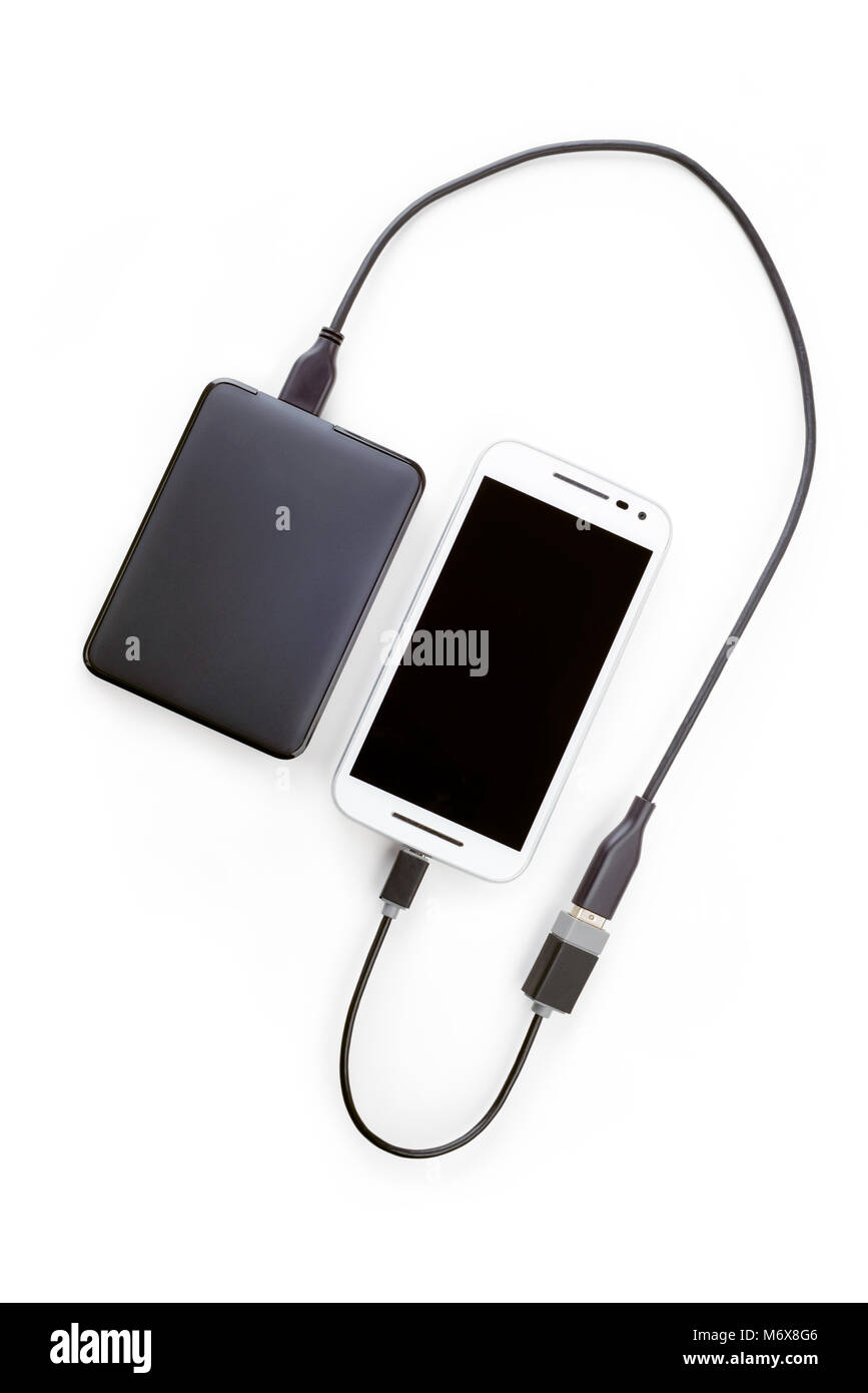White smartphone connected to a black hard disk drive with an OTG cable.  Isolated on white background Stock Photo - Alamy
