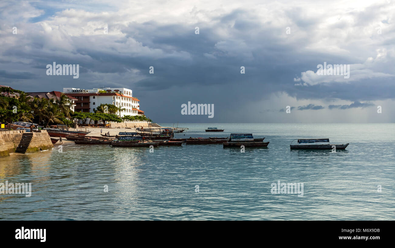 Stone Town, Zanzibar - February 8, 2017: Seafront with boats on calm sea. Stock Photo