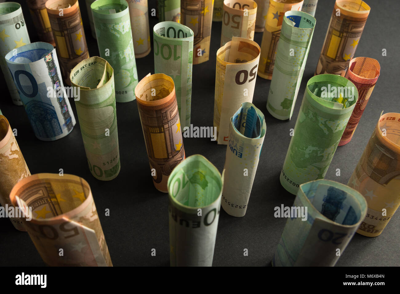 Money euro banknotes in rolls in a dark background Stock Photo - Alamy