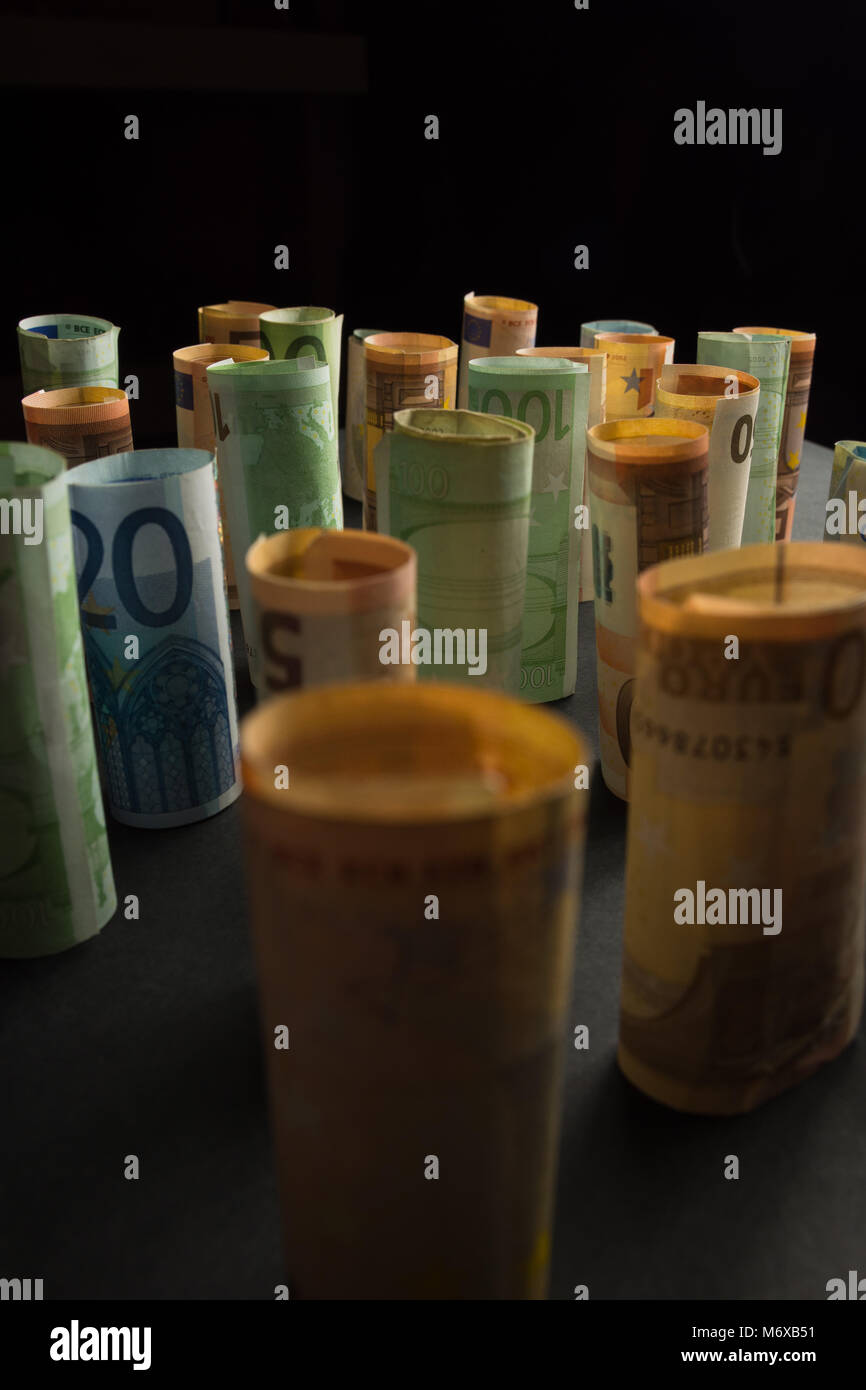 Money euro banknotes in rolls in a dark background Stock Photo - Alamy