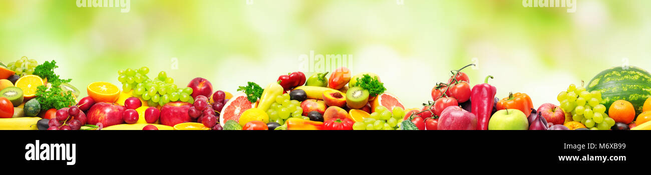 Panoramic collection fresh fruits and vegetables for skinali on blur green background. Copy space Stock Photo