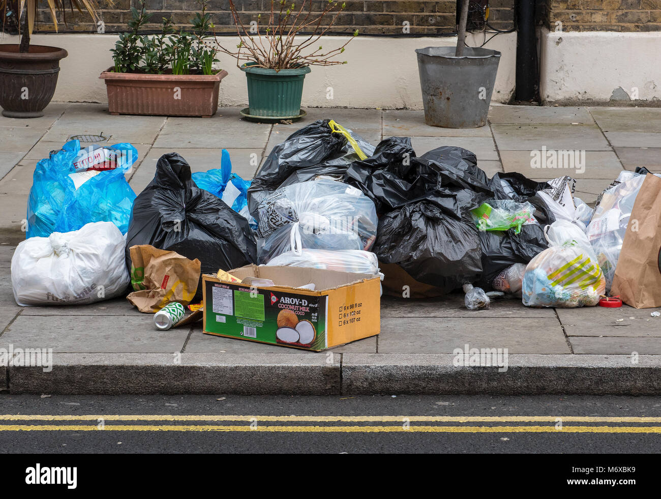 Pile of rubbish and bin bags left at the side of the road on the