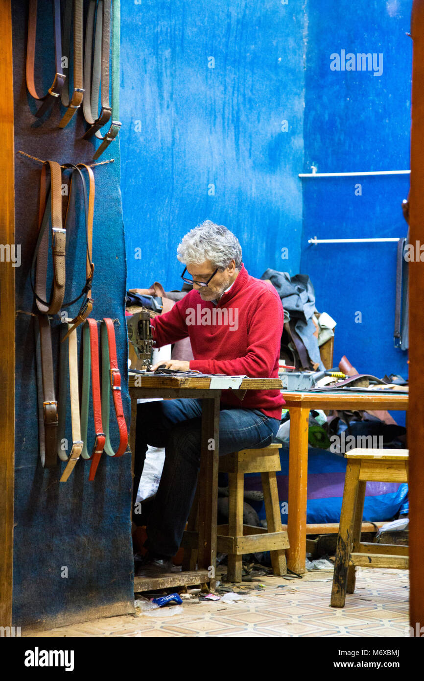 A leather artisan working in his workshop in Fes, Morocco Stock Photo