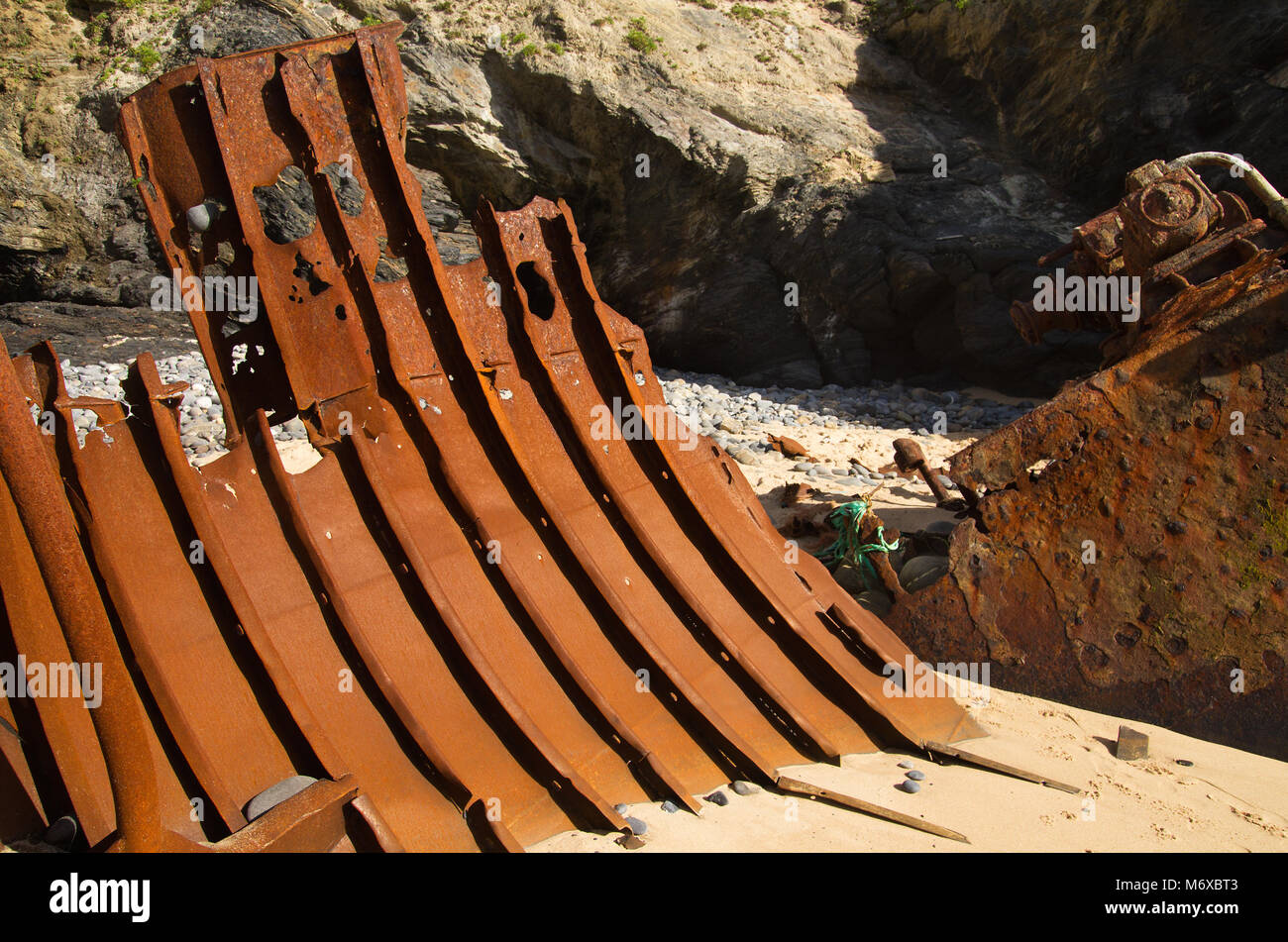 Part of the hull of a wrecked push boat looking like metal rusted ribs ...