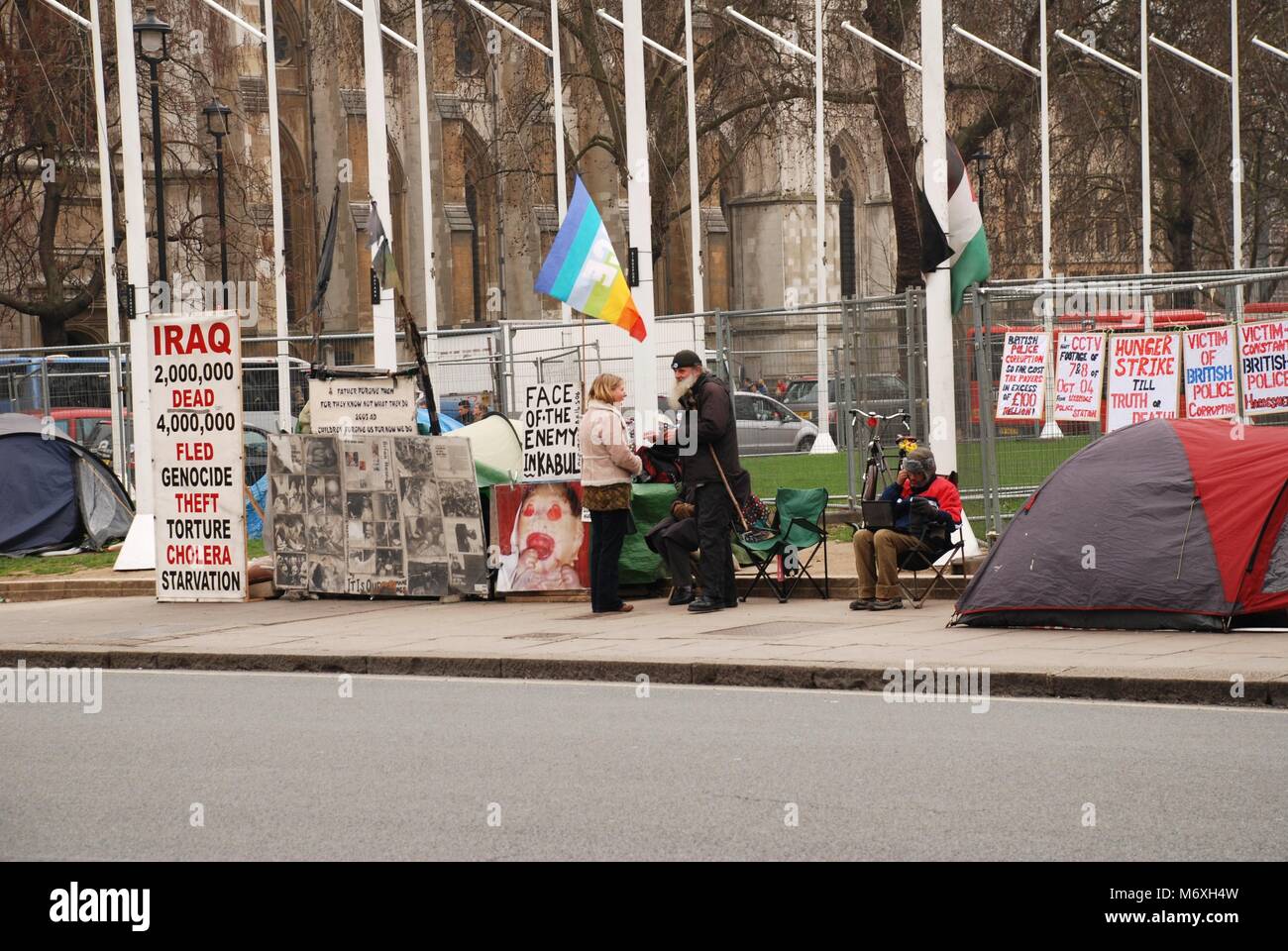 Various protestors stands opposite the Houses of Parliament in Parliament Square, London on March 17, 2011. Stock Photo