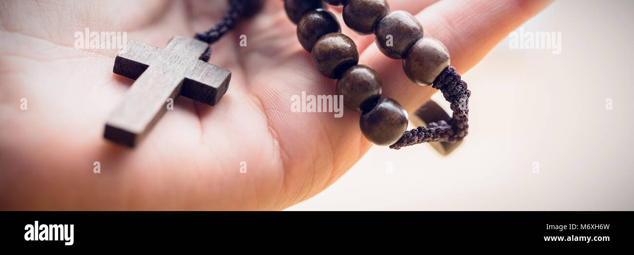 Hand holding rosary beads Stock Photo