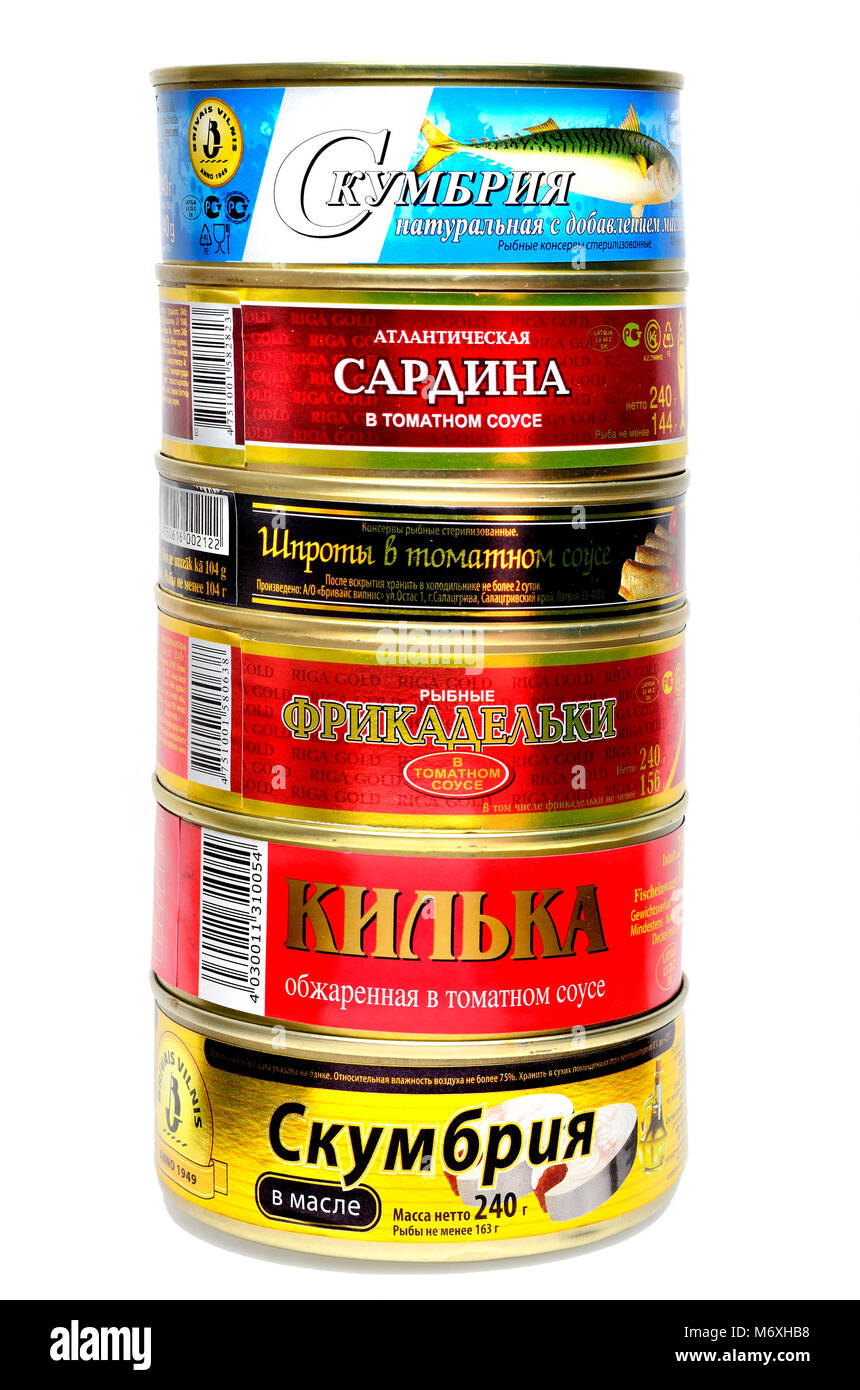 Canned fish from Eastern Europe with labels in Cyrilic script. From top: mackerel, sardines, sprats, fish balls in tomato sauce, sprats, mackerel. Stock Photo