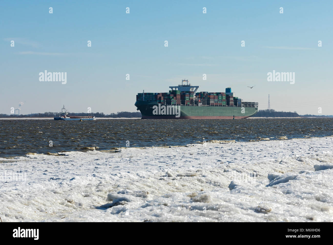 Stade, Germany - March 1, 2018: Container ship TOLEDO TRIUMPH on Elbe river. It is 365 meters long and holds up to 13870 standard containers. Stock Photo