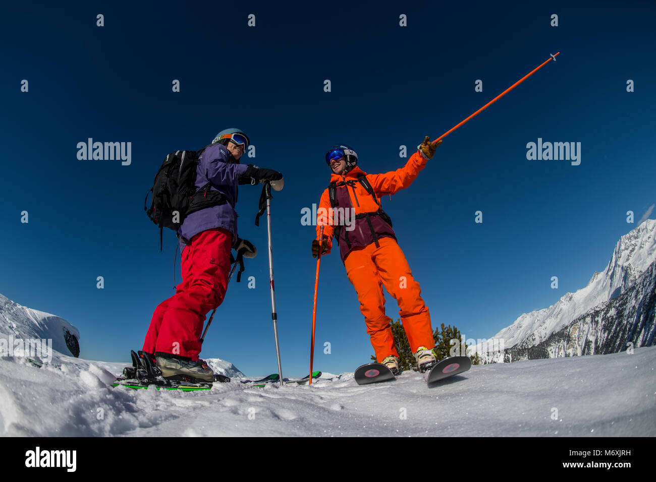A male ski instructor teaches a woman in the French Alpine resort of Courchevel. Stock Photo