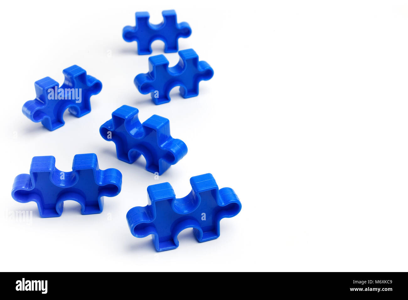 Pieces from a colorful jigsaw puzzle on white background. Break barriers together for autism. Stock Photo