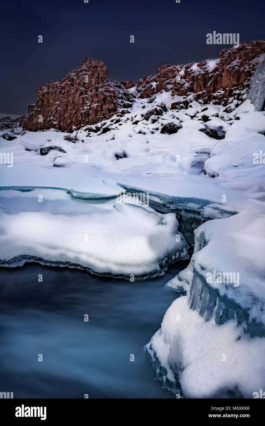 Wintertime by Oxararfoss Waterfall, Thingvellir National Park, Iceland. Unesco World Heritage Site. Stock Photo