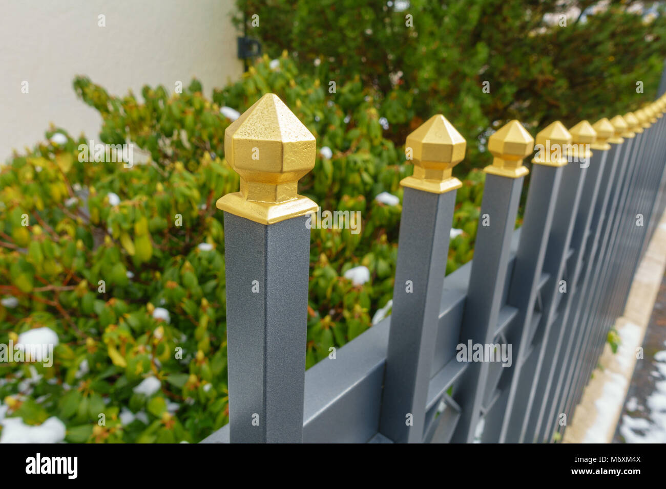 a metallic fence with a golden tip Stock Photo Alamy