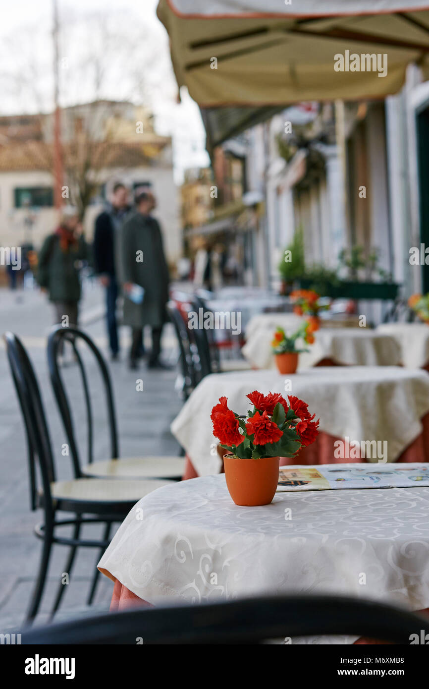 tables and chairs outside a cafe in venice Stock Photo