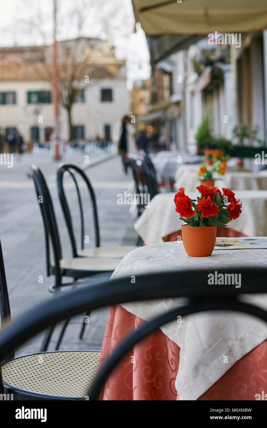 tables and chairs outside a cafe in venice Stock Photo