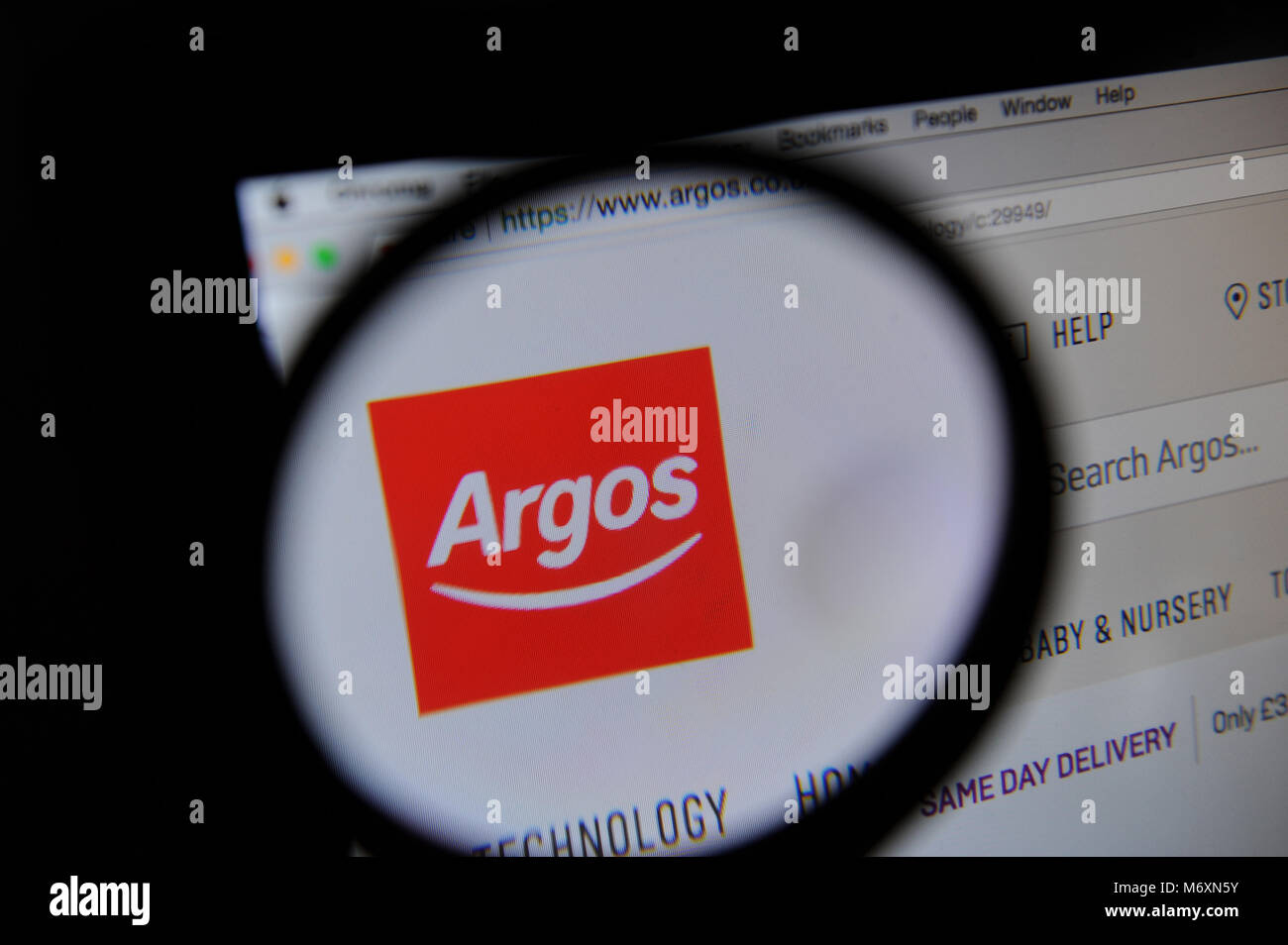 The Argos website is seen through a magnifying glass Stock Photo Alamy