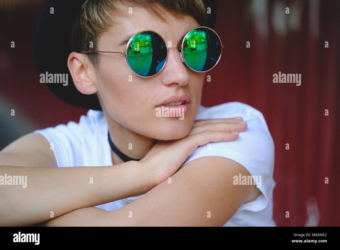 Young woman portrait wearing stylish hat and round glasses Stock Photo