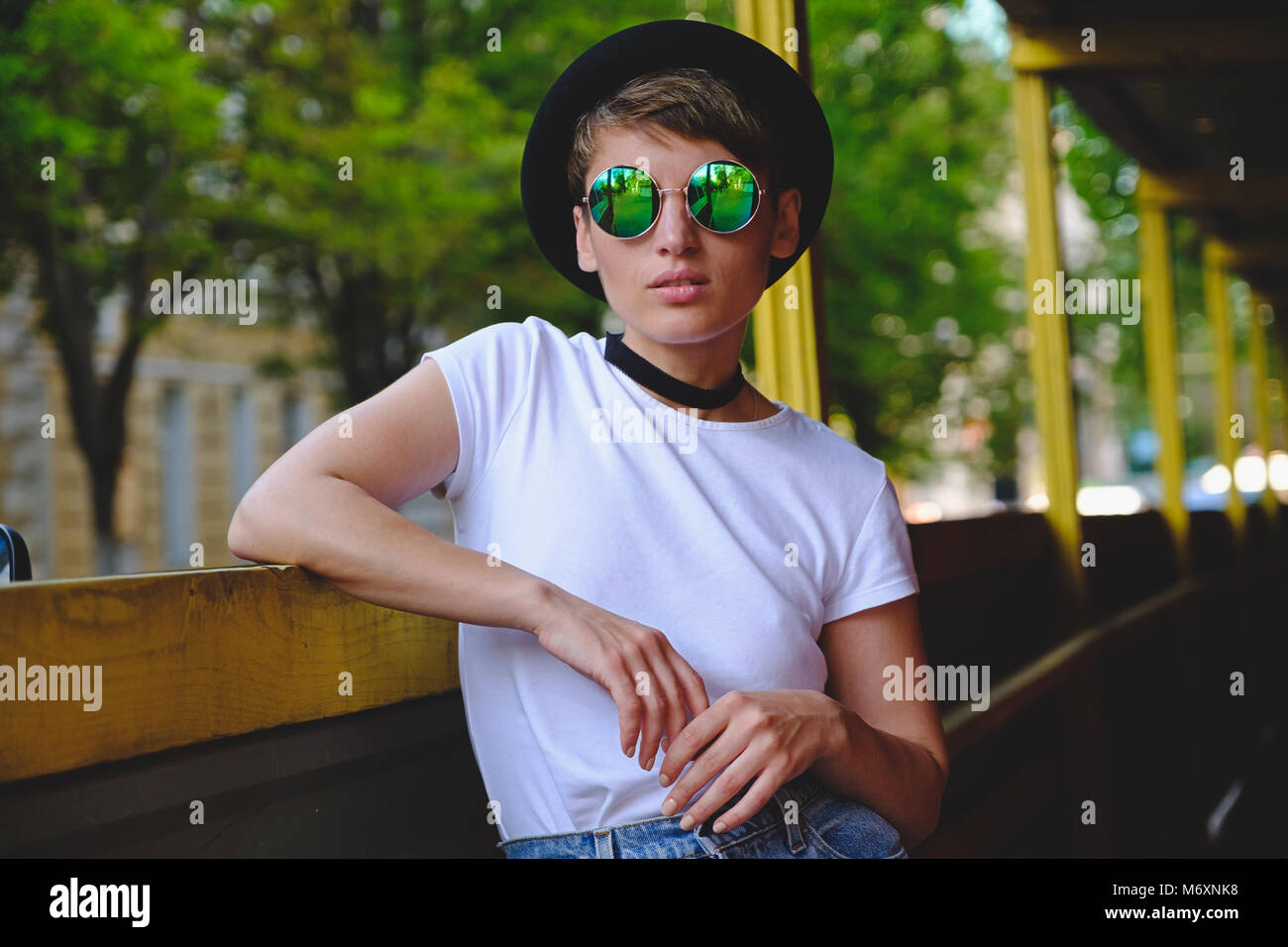 Young woman portrait wearing stylish hat and round glasses Stock Photo