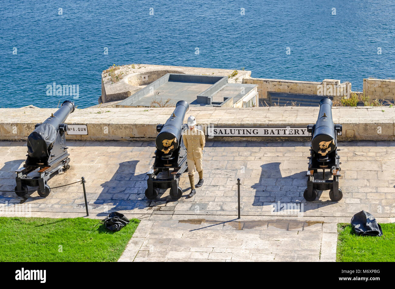 Valletta, Malta - November 8, 2015: View of  Saluting Battery from the Upper Barrakka Gardens, with the guard in uniform preparing a cannon shot Stock Photo