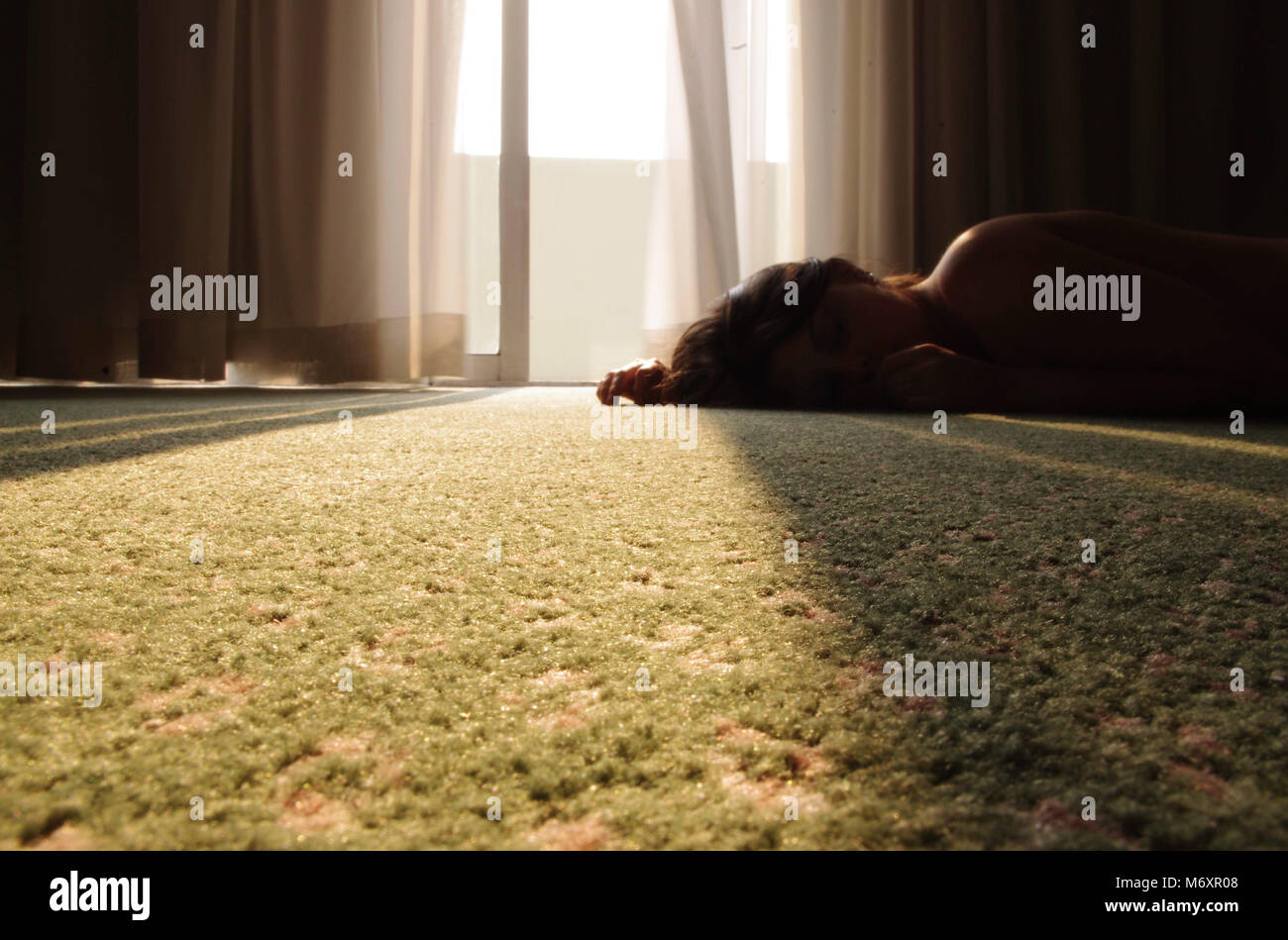 Girl lying naked on the floor, in a Hotel room Stock Photo Alamy