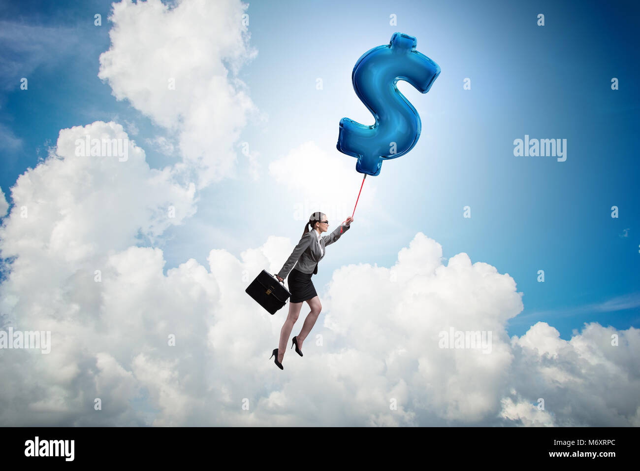 Businesswoman flying on dollar sign inflatable balloon Stock Photo - Alamy