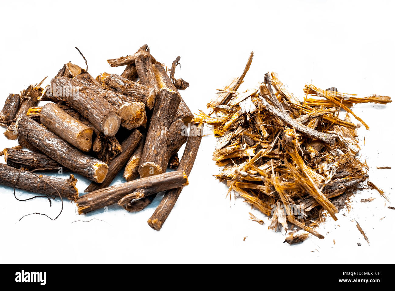 Close up of Ayurvedic herb Liquorice root,Licorice root, Mulethi or Glycyrrhiza glabra root with its powder  isolated on white is very much beneficial Stock Photo
