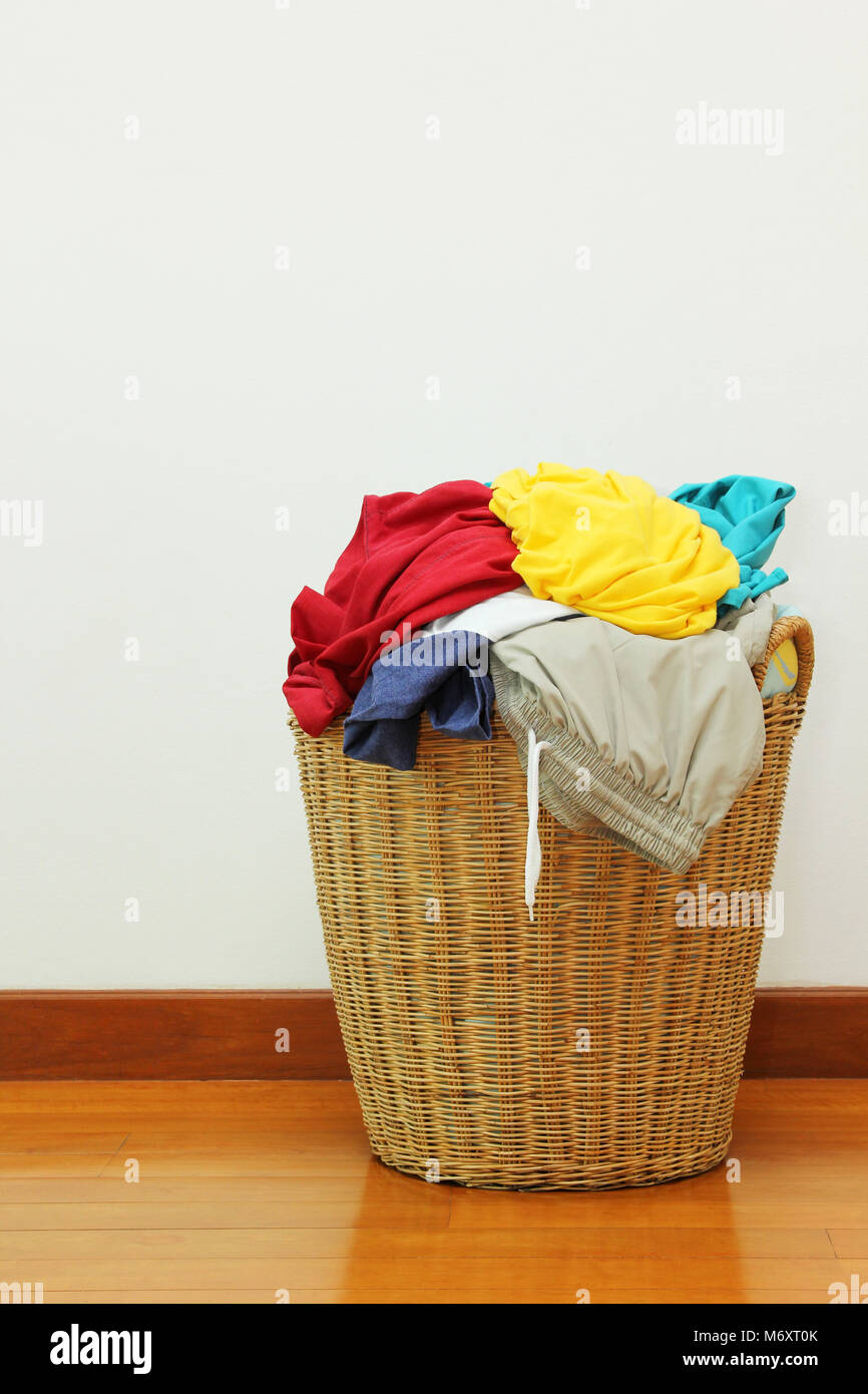 Clothing in laundry basket made of rattan Stock Photo Alamy