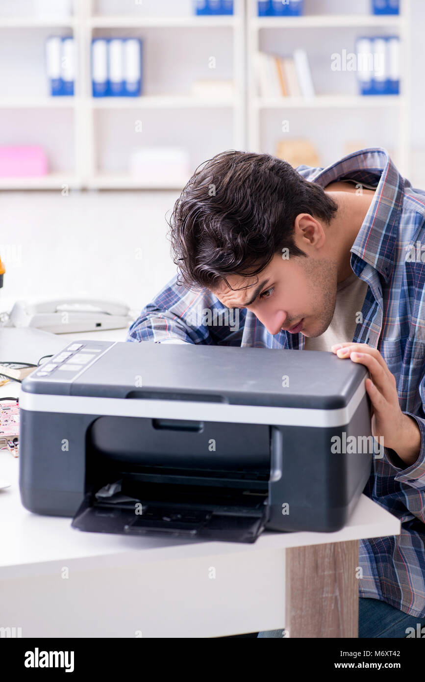 Hardware repairman repairing broken printer fax machine Stock Photo Alamy