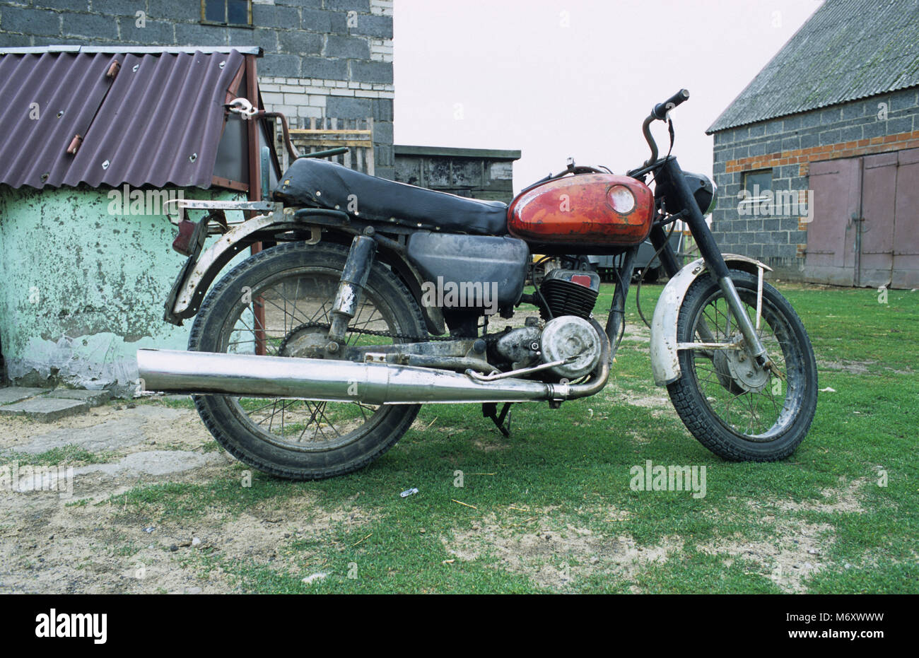 Motorbike parked in a farmyard in the Kujawy region in Poland. Stock Photo