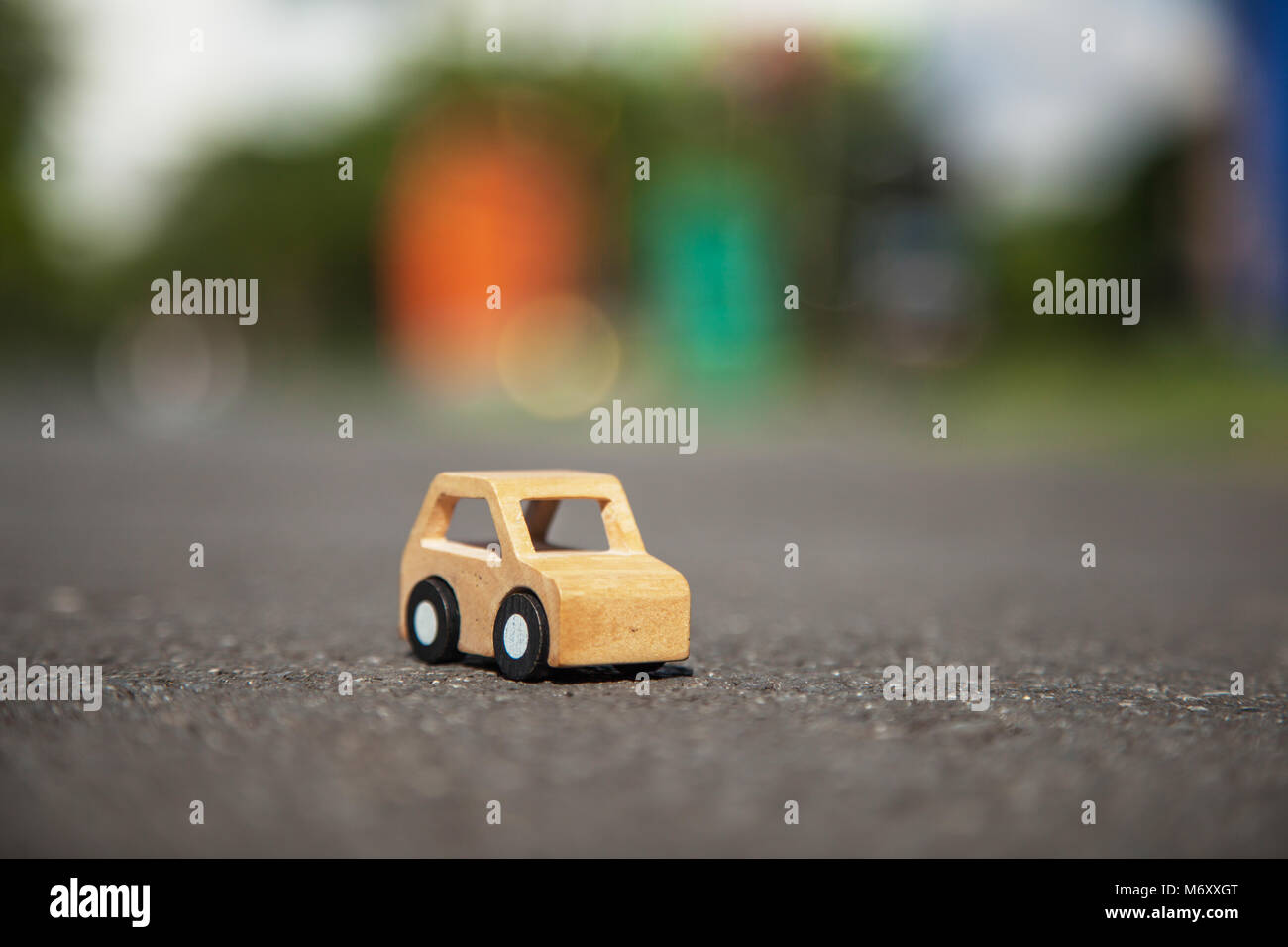 Wooden car model on the road. Stock Photo