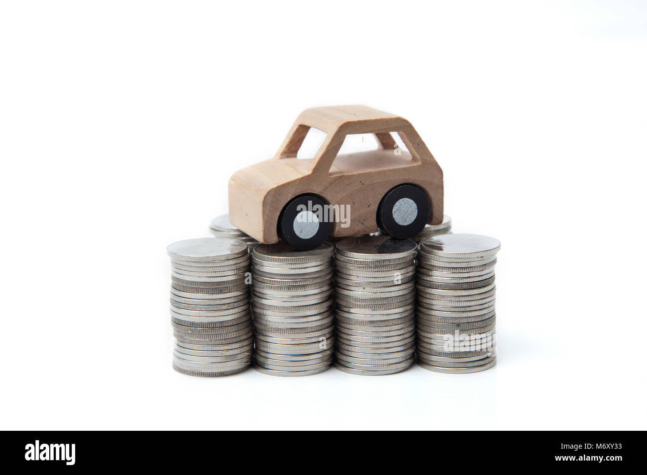 Wooden car model on the coins Stock Photo