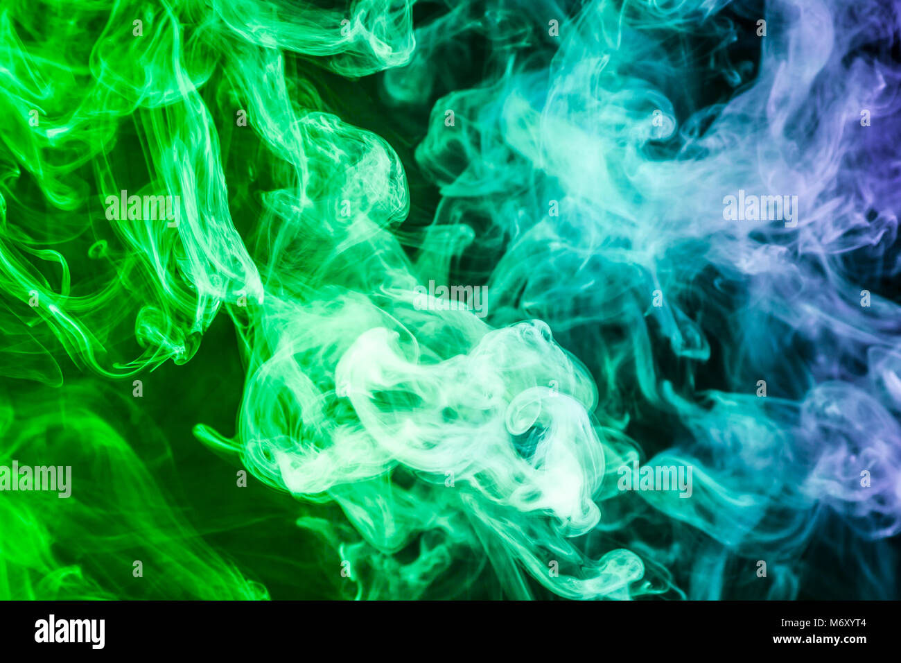 Colorful smoke of blue, green on a black isolated background. Background  from the smoke of vape Stock Photo - Alamy