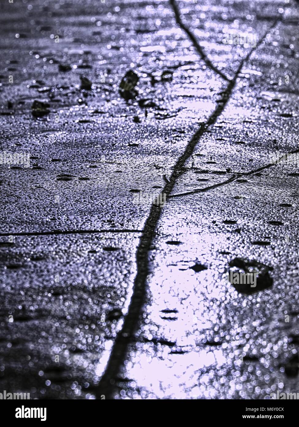 sparkling shards of cracked ice jut out on the frozen lake. The light effect occurs in deep and shallow cracks of sublime ice. Follow the depth of fie Stock Photo