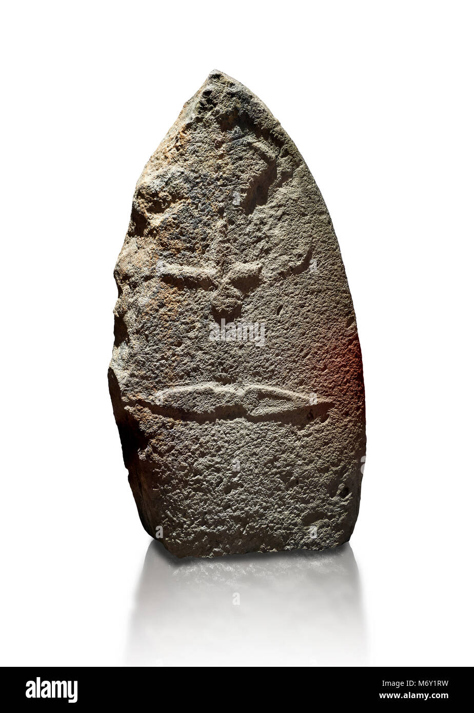 Late European Neolithic prehistoric Menhir standing stone with carvings on its face side. The representation of a stylalised male figure starts at the Stock Photo