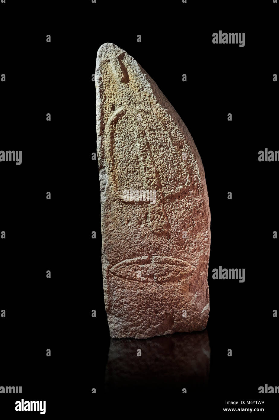 Late European Neolithic prehistoric Menhir standing stone with carvings on its face side. The representation of a stylalised male figure starts at the Stock Photo