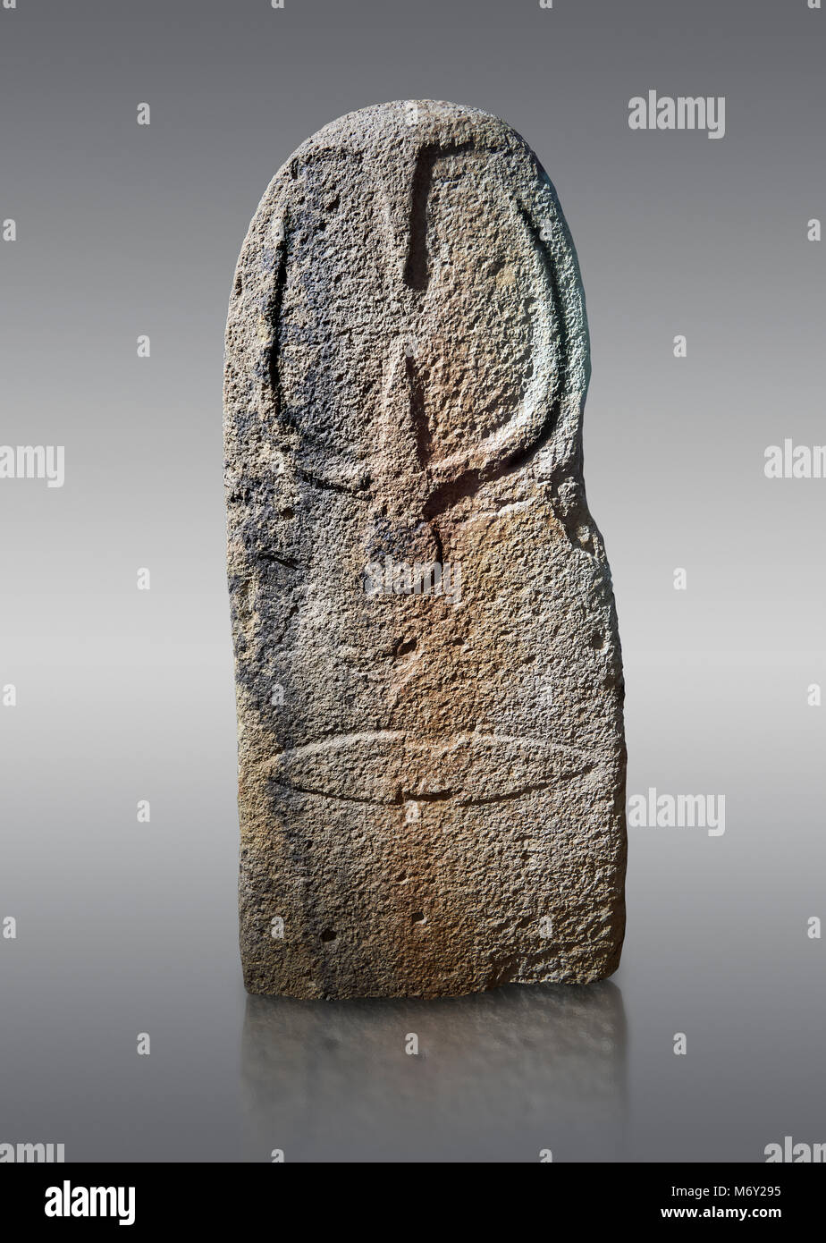 Late European Neolithic prehistoric Menhir standing stone with carvings on its face side. The representation of a stylalised male figure starts at the Stock Photo