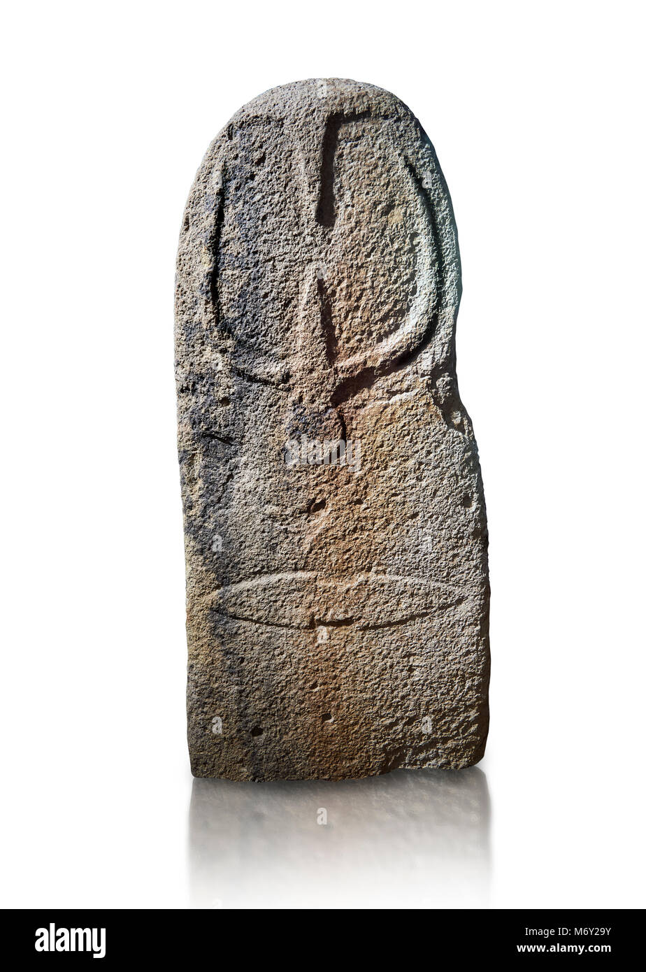 Late European Neolithic prehistoric Menhir standing stone with carvings on its face side. The representation of a stylalised male figure starts at the Stock Photo