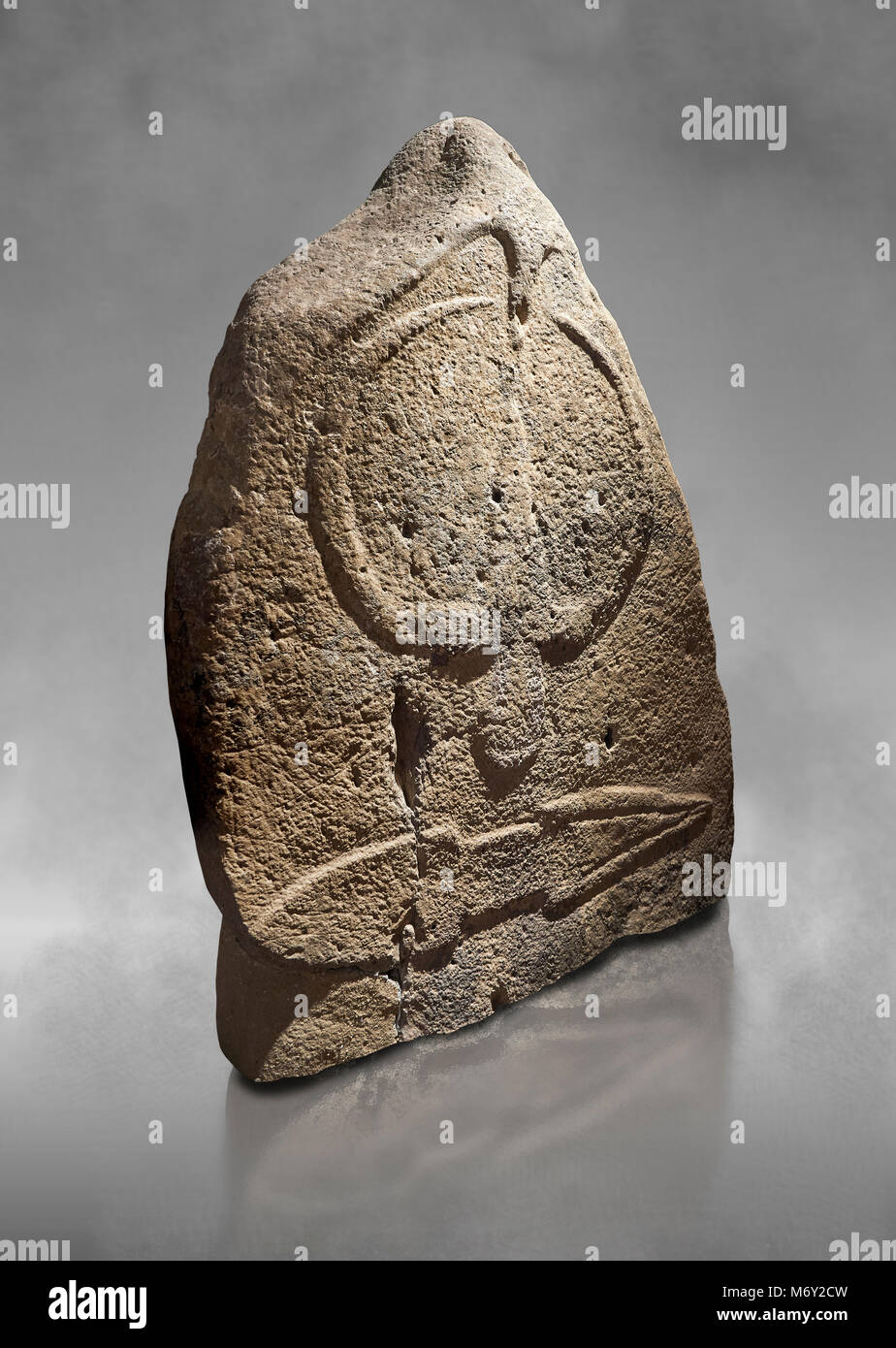 Late European Neolithic prehistoric Menhir standing stone with carvings on its face side. The representation of a stylalised male figure starts at the Stock Photo