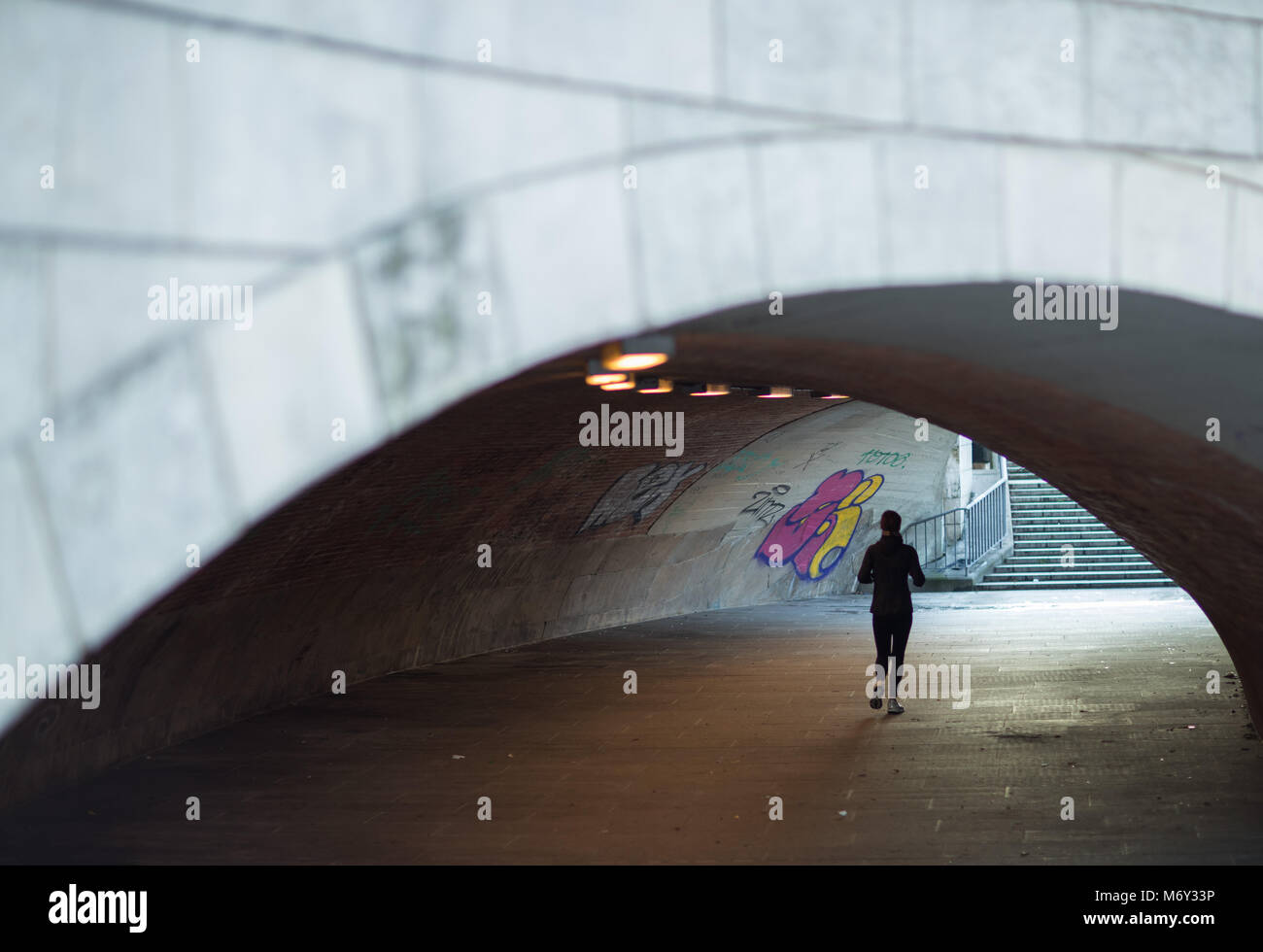 A jogger in a subway on the banks of the River Spree, Mitte, Berlin, Germany Stock Photo