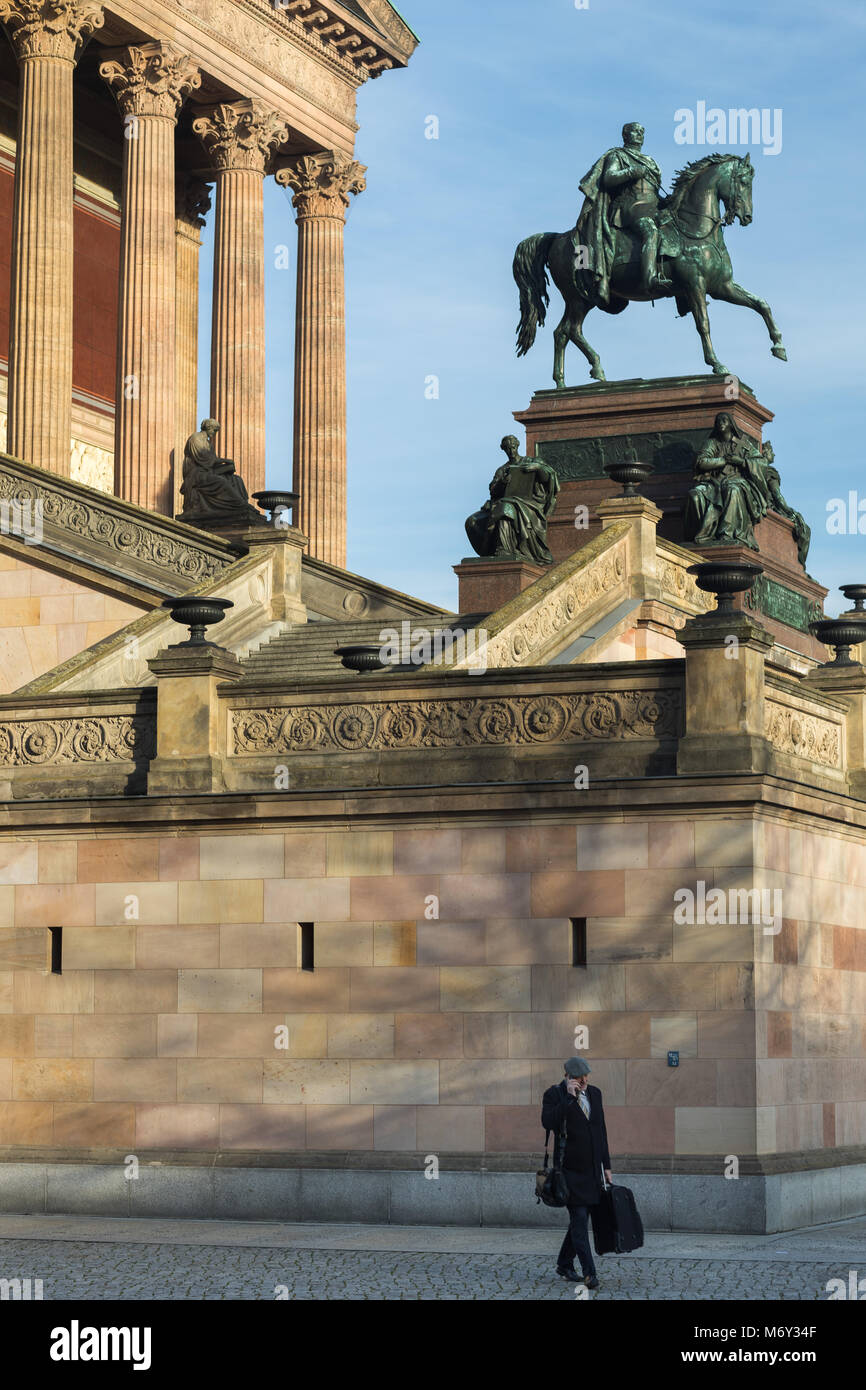 A man on his phone in front of the Alte Nationalgalerie, Mitte, Berlin, Gernany Stock Photo